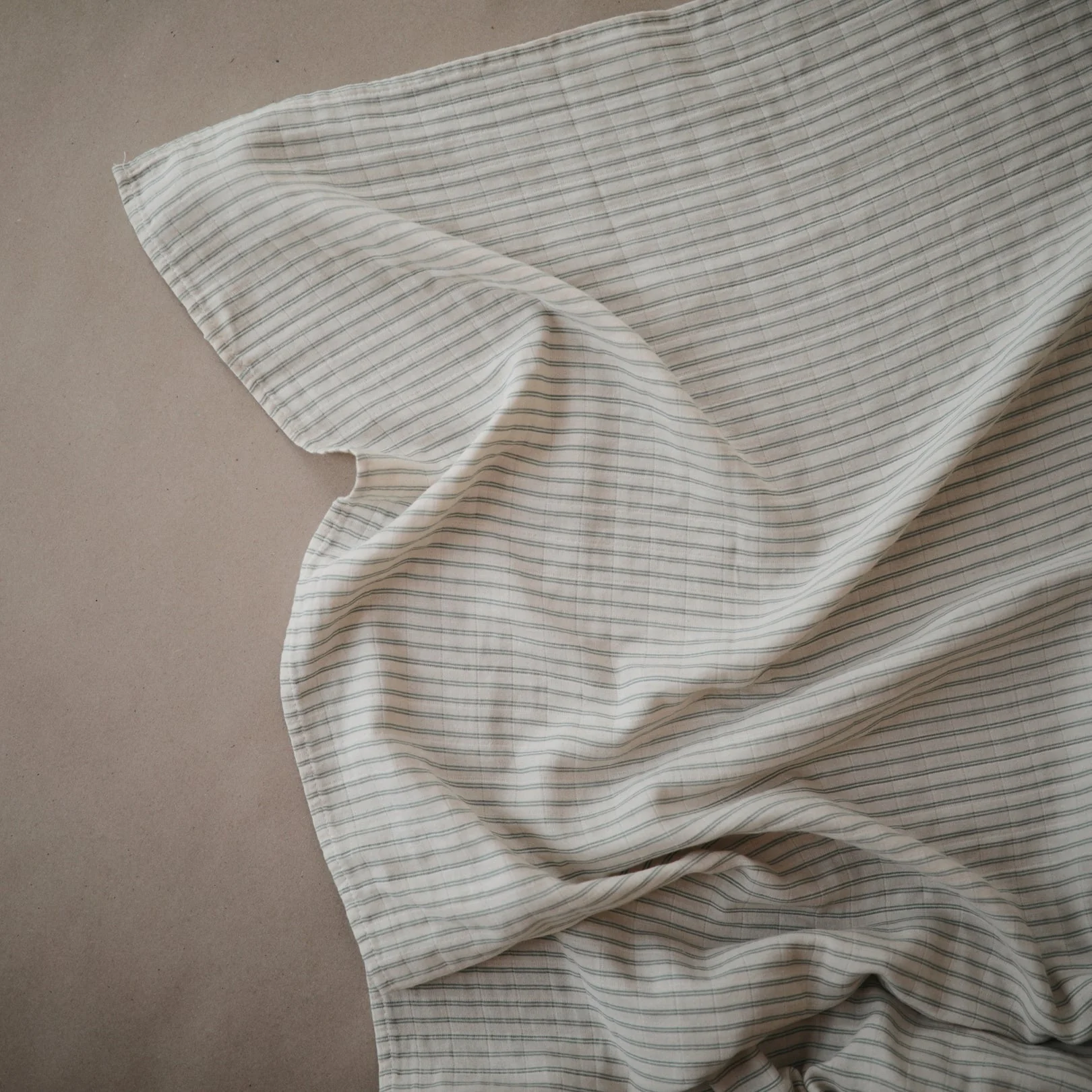 Organic Muslin Swaddle - Sage Stripe by Mushie & Co - Image 2